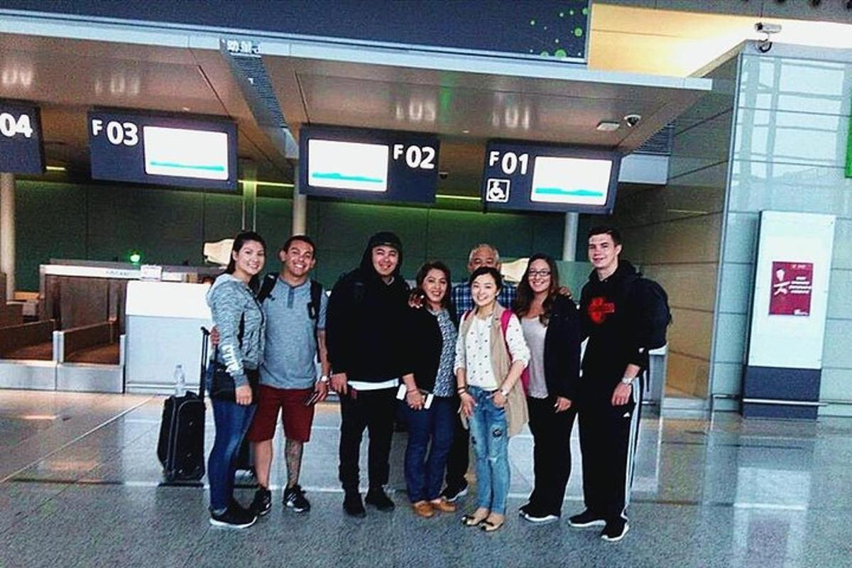 a group of people posing for a picture in an airport