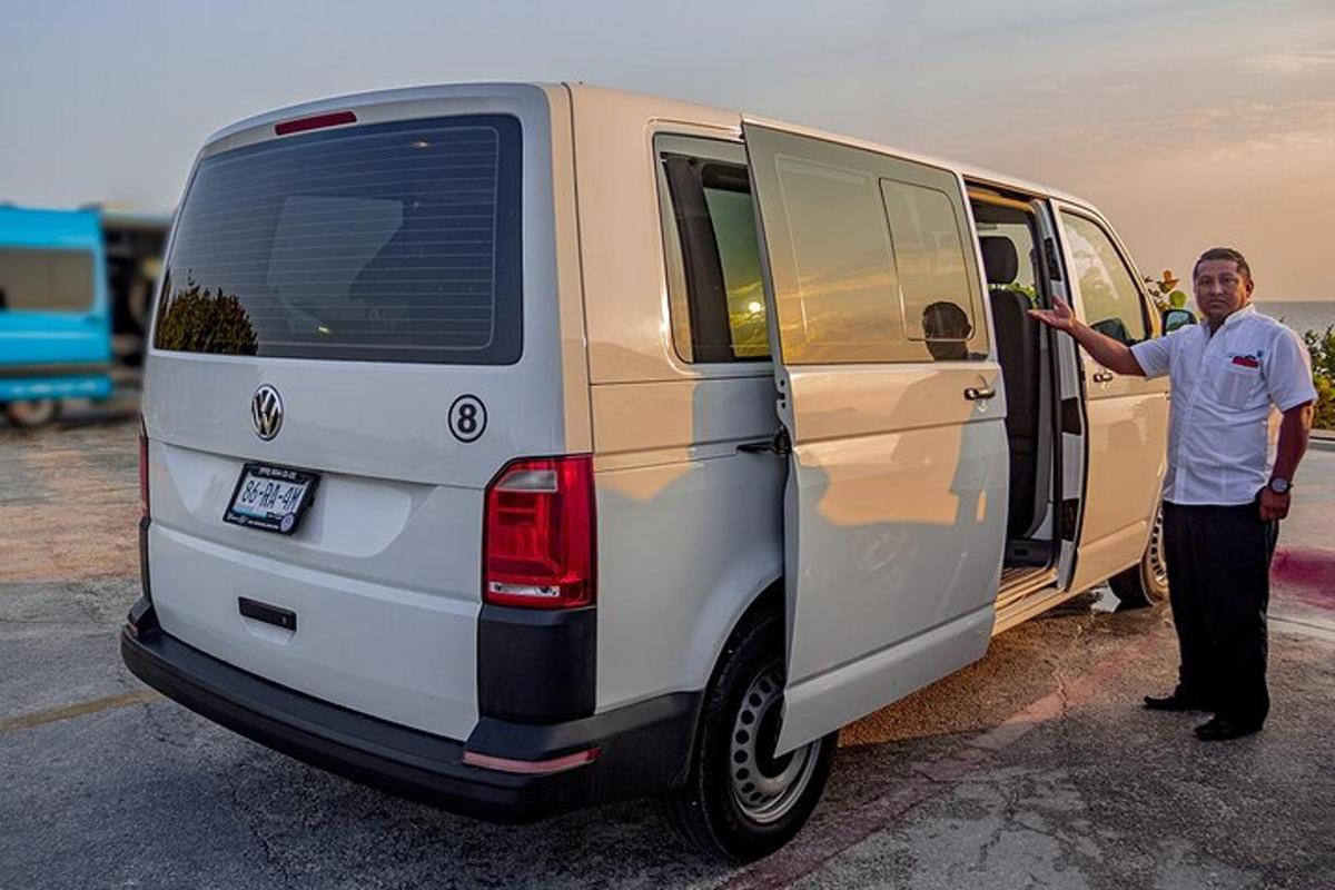 a man is standing next to a white van