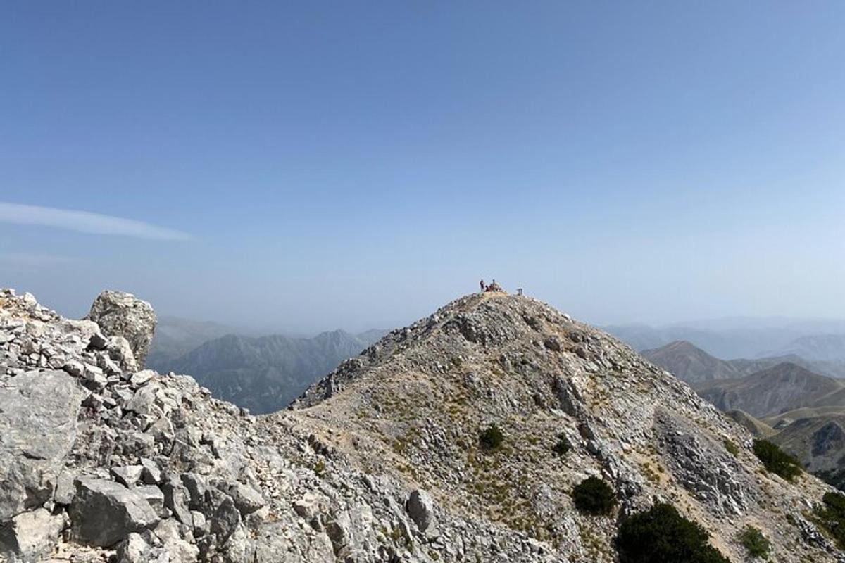 a person sitting on the top of a mountain