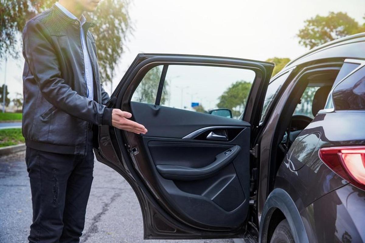 a man is getting out of a car door