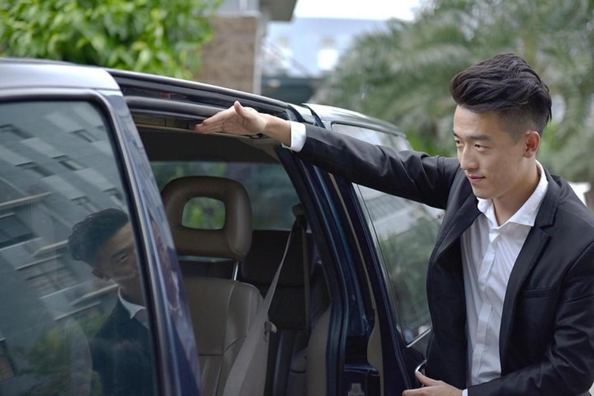 a man in a suit getting out of a car