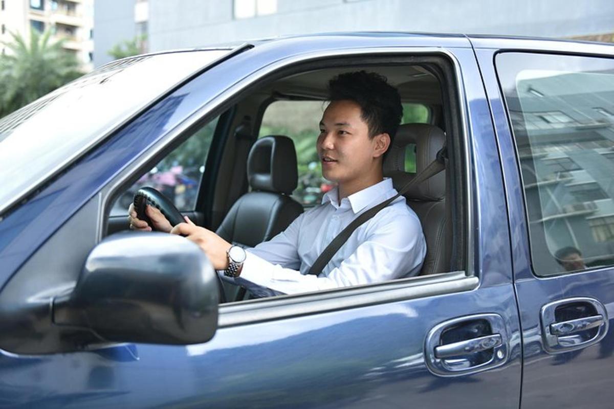 a man is driving a blue car