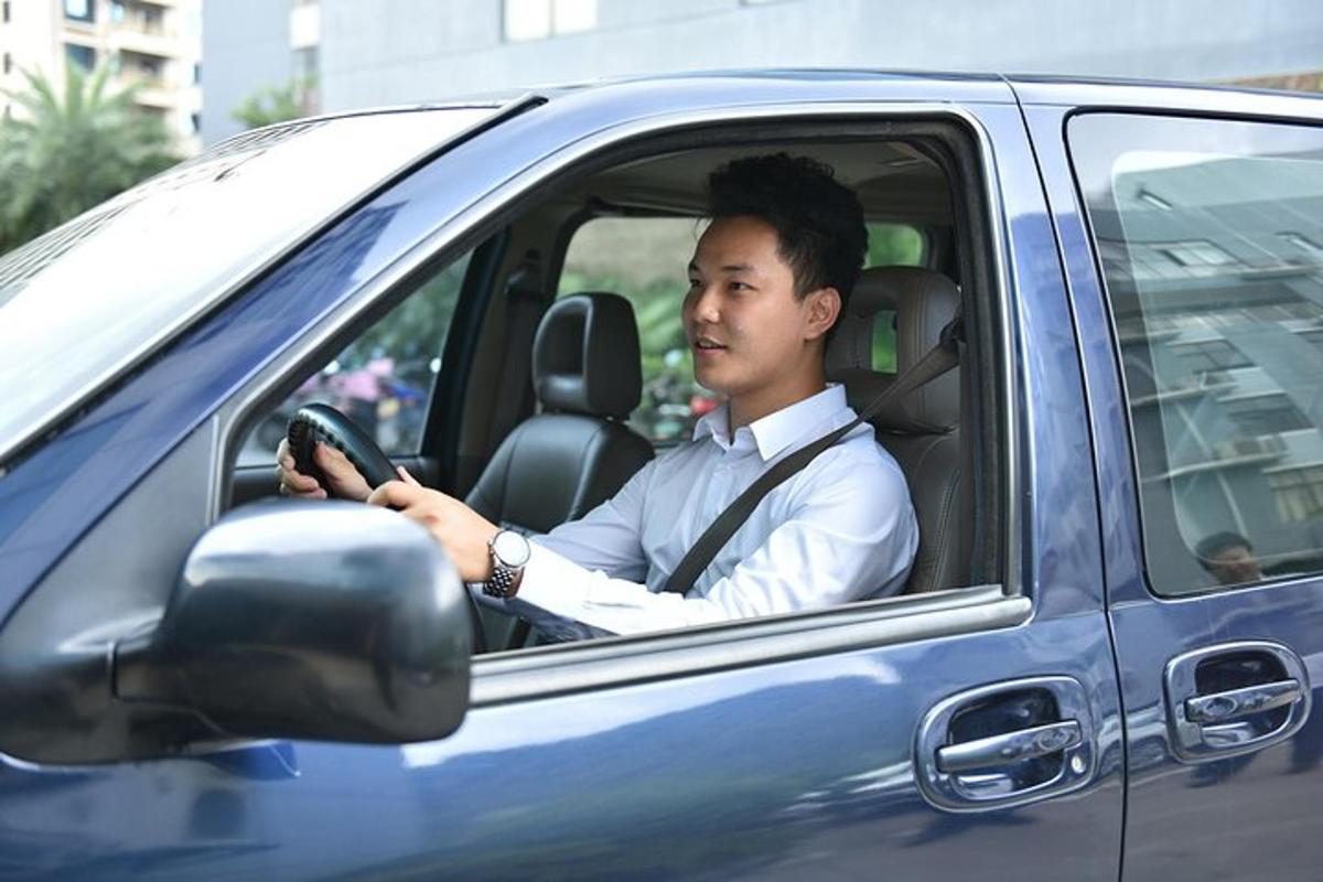 a man is driving a blue car