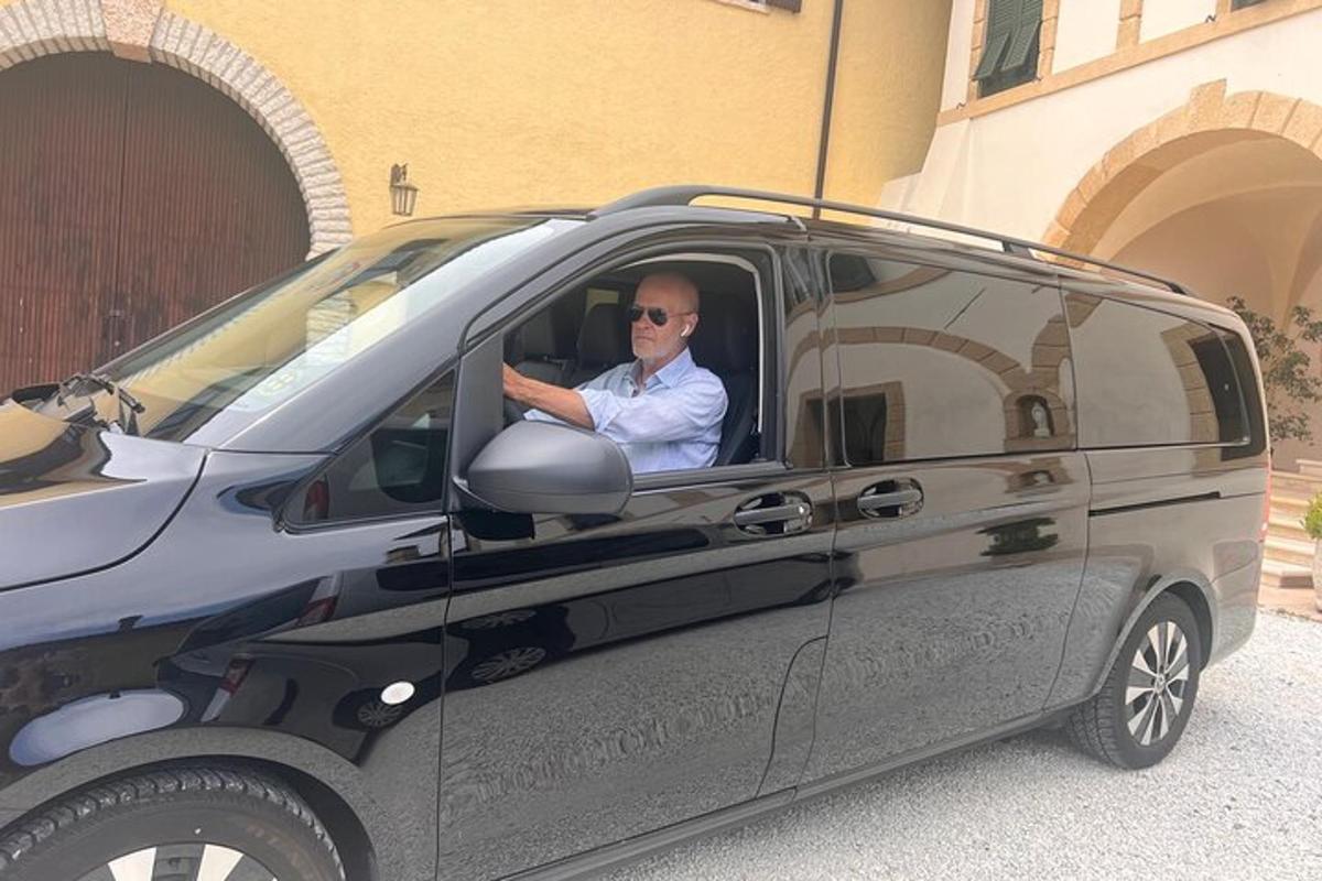 a man sitting in the drivers seat of a van