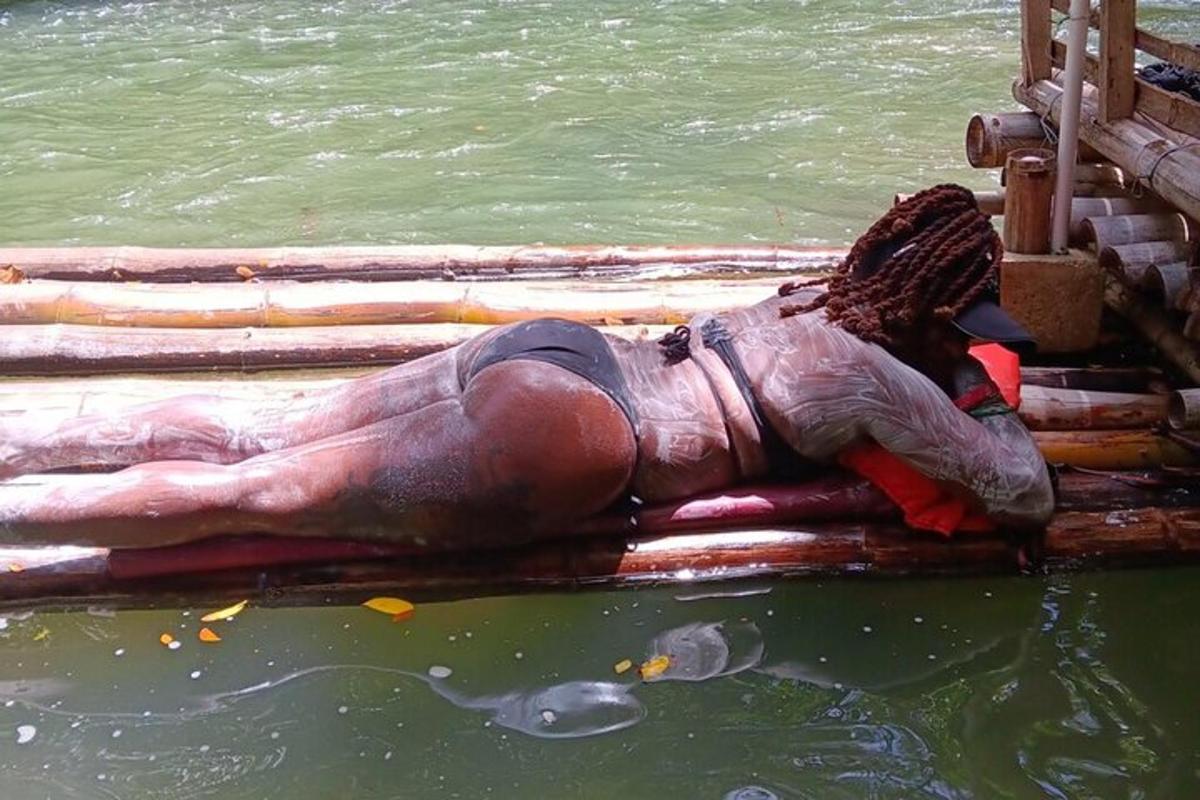 a statue of a man laying in the water