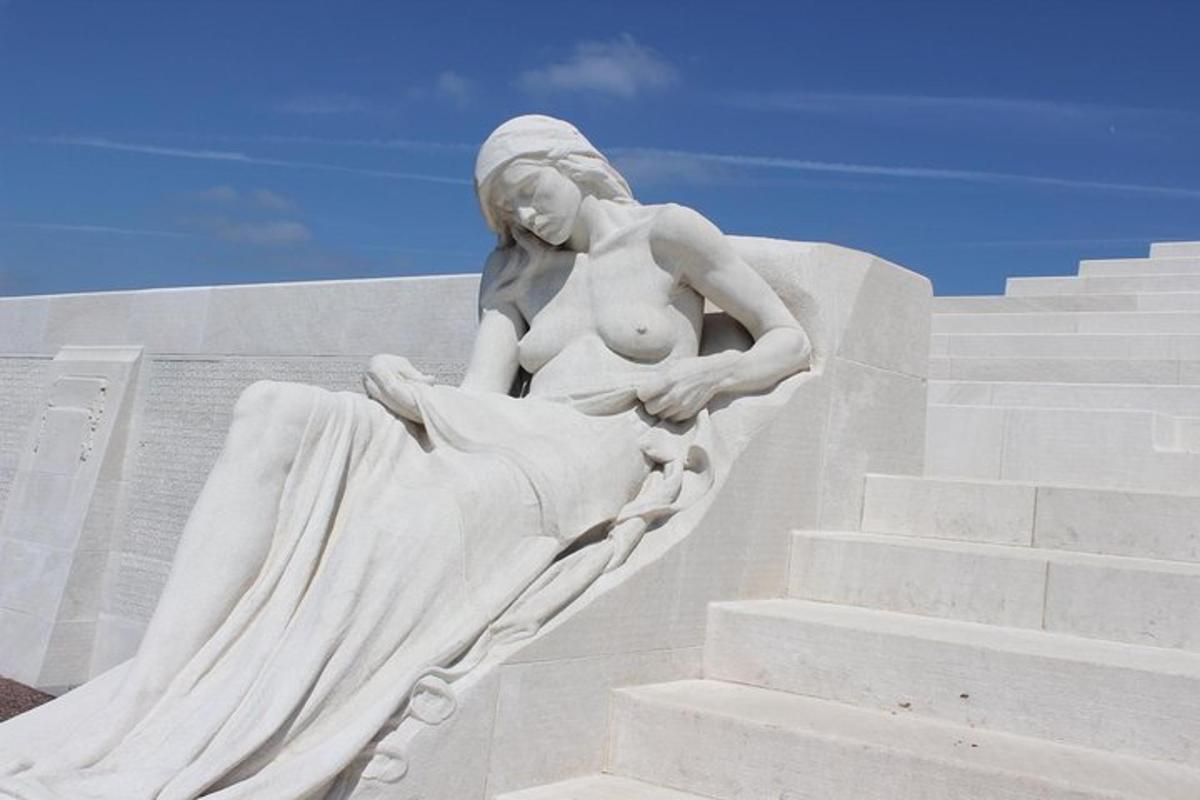 a statue of a woman sitting on some stairs