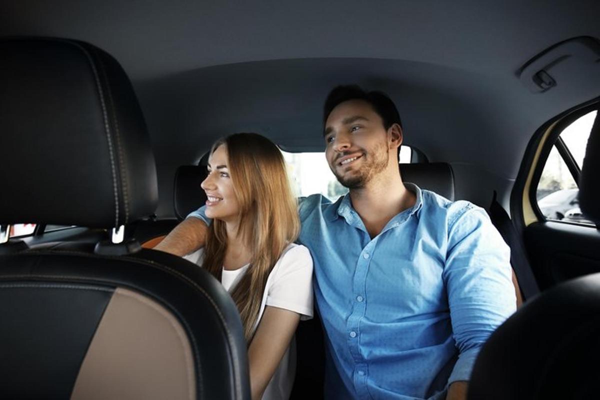a man and a woman sitting in a car