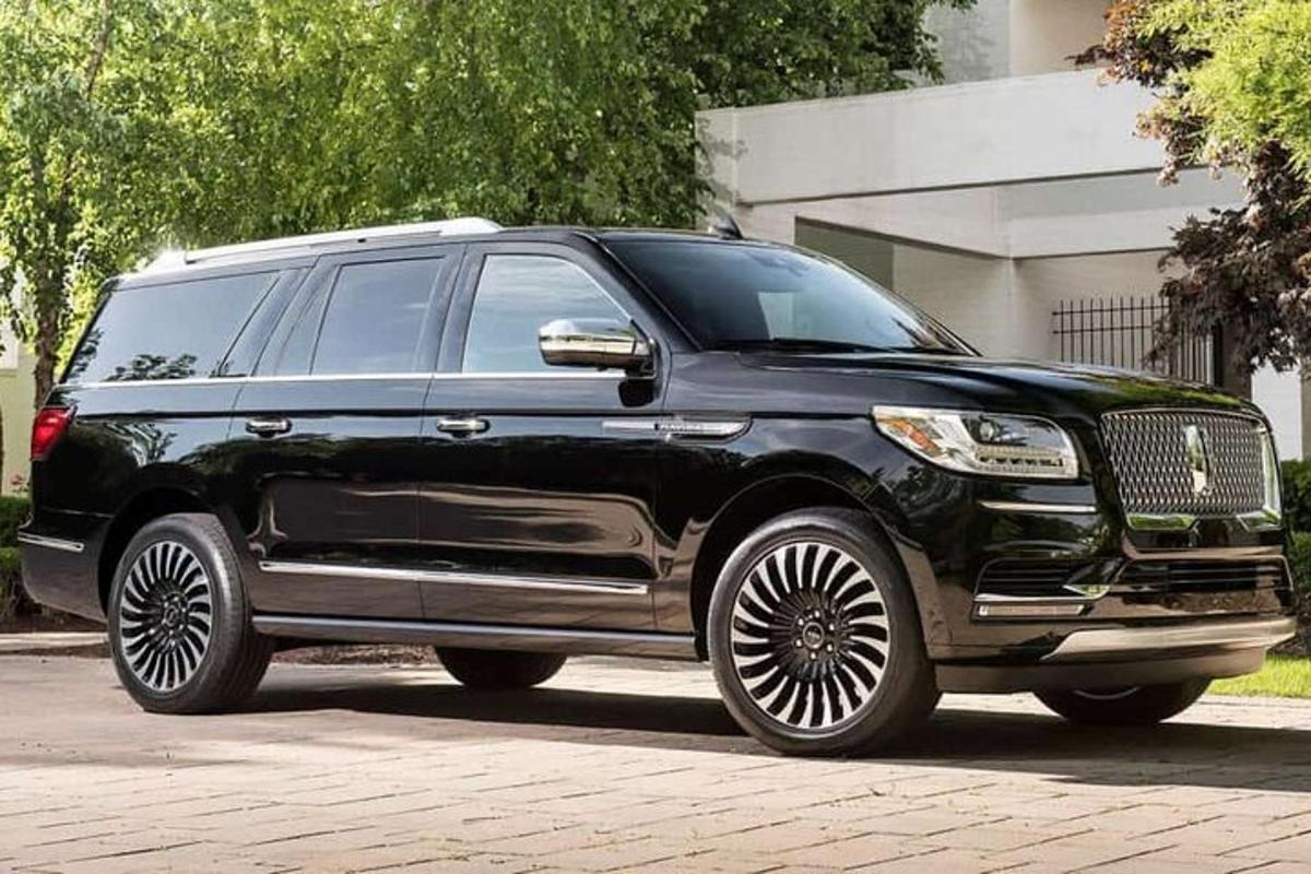 a black vehicle parked on a brick road