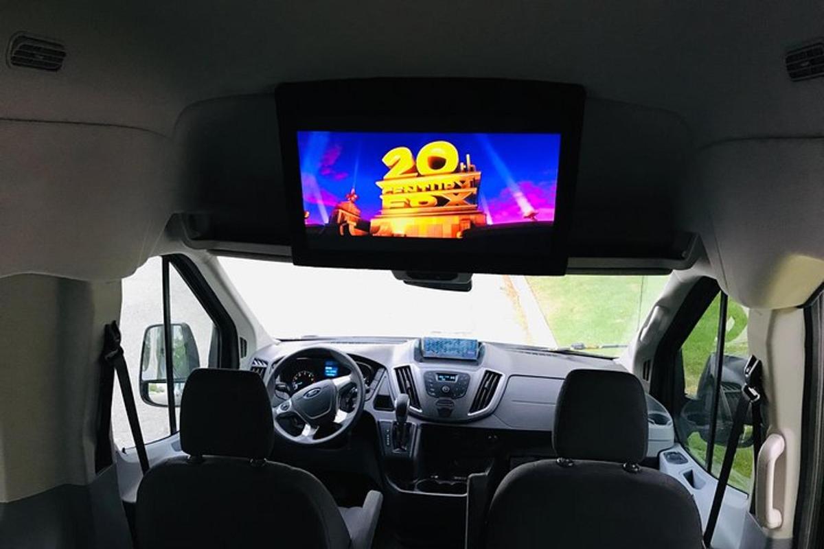 a view from the inside of a car with a television