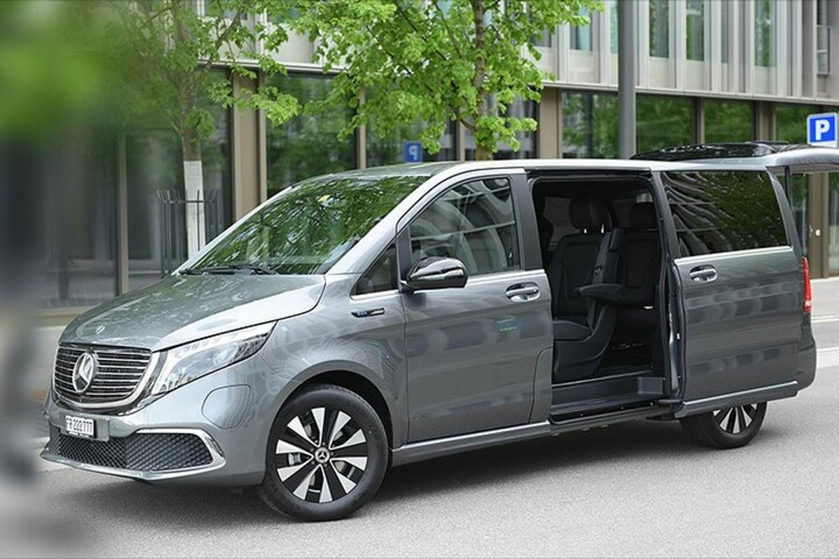 a silver van is parked on a city street
