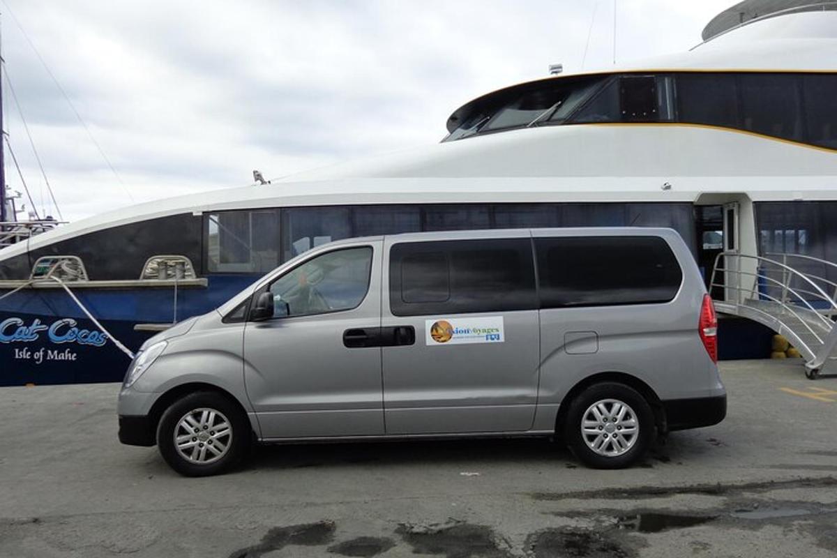 a van parked in a parking lot next to a boat