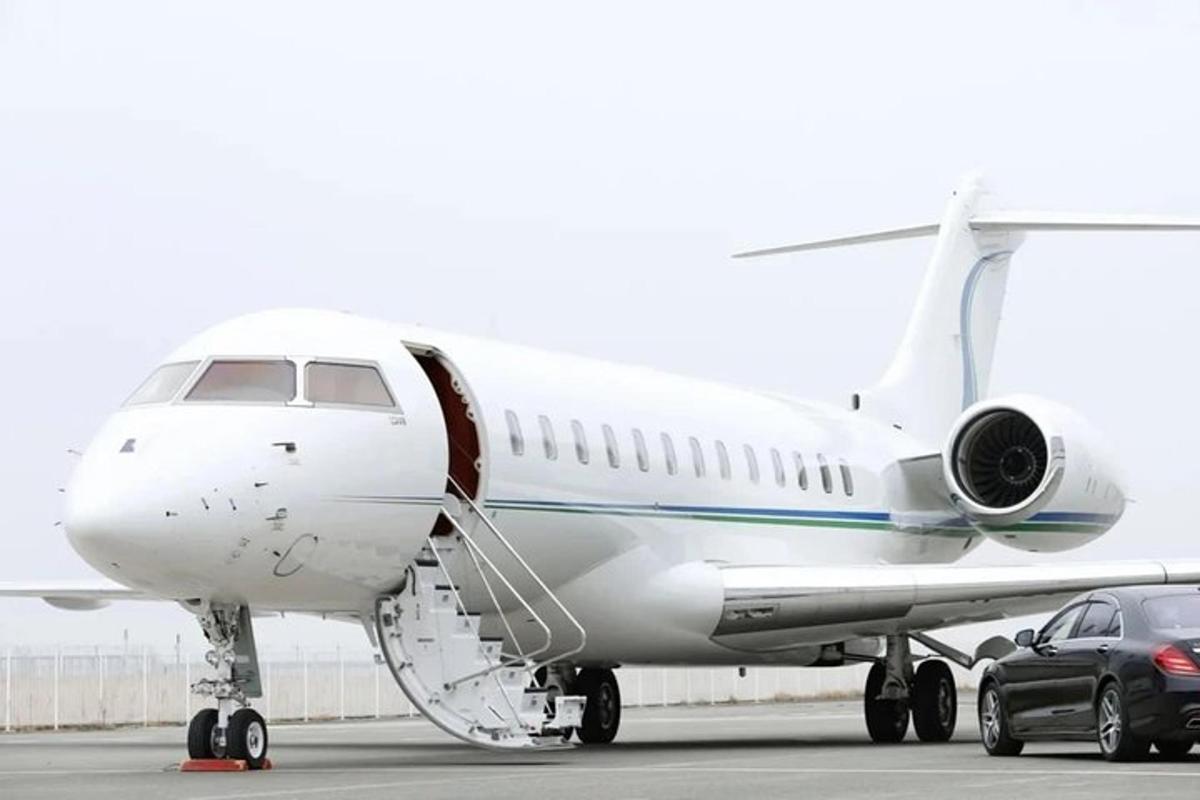 a plane parked on a runway with a car next to it