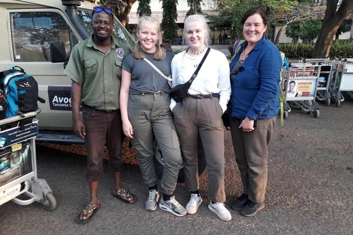 a group of people standing in front of a truck