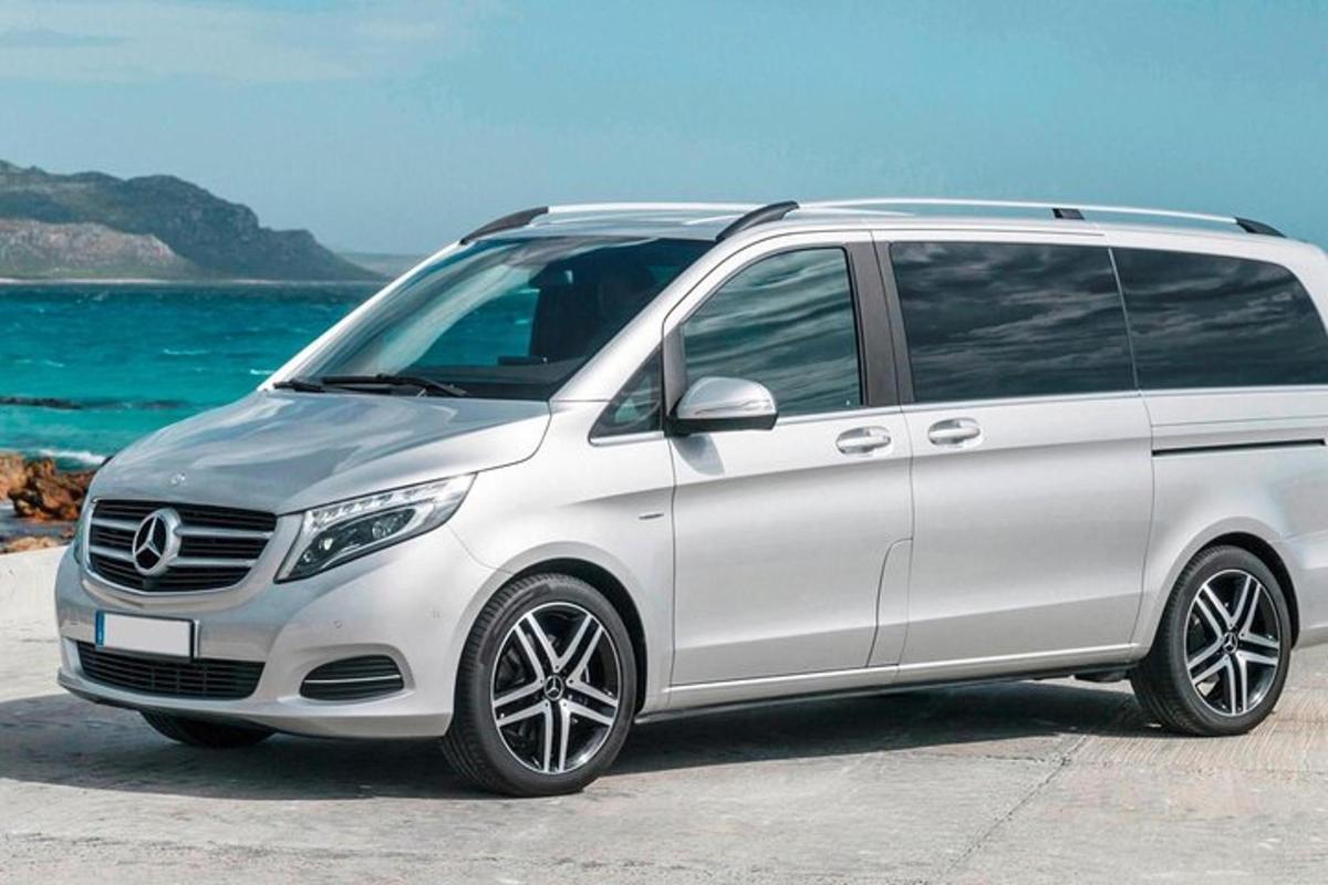 Beli volkswagenov enoprostorec parkiran ob oceanu