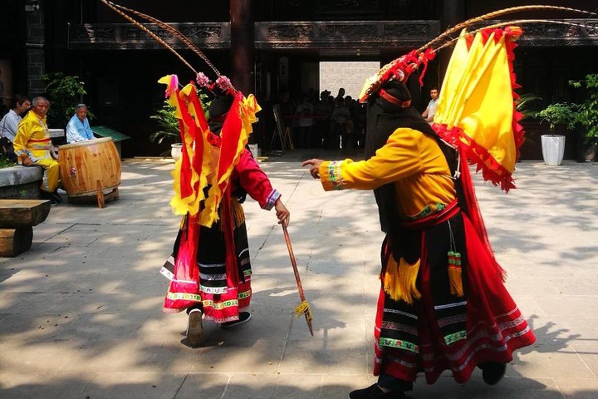 two people dressed in costumes walking around a courtyard