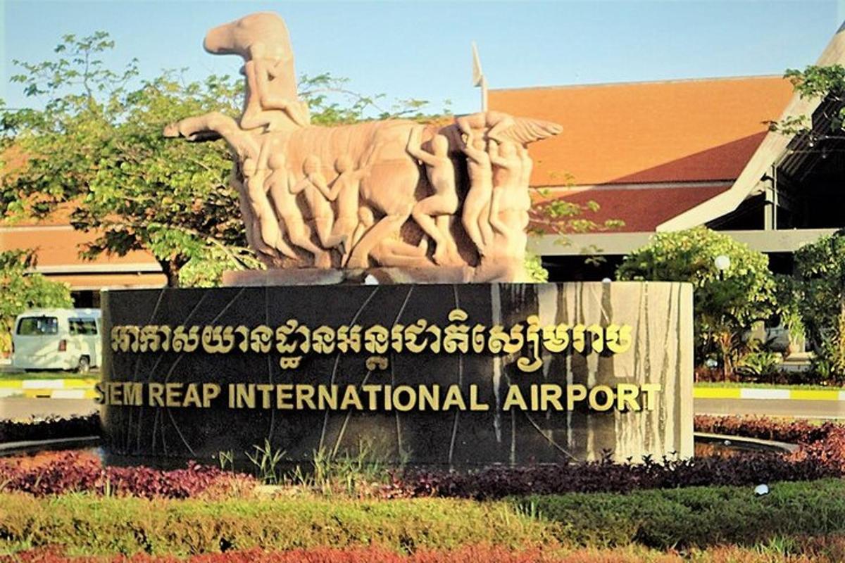 uma estátua em frente a uma placa de um aeroporto internacional