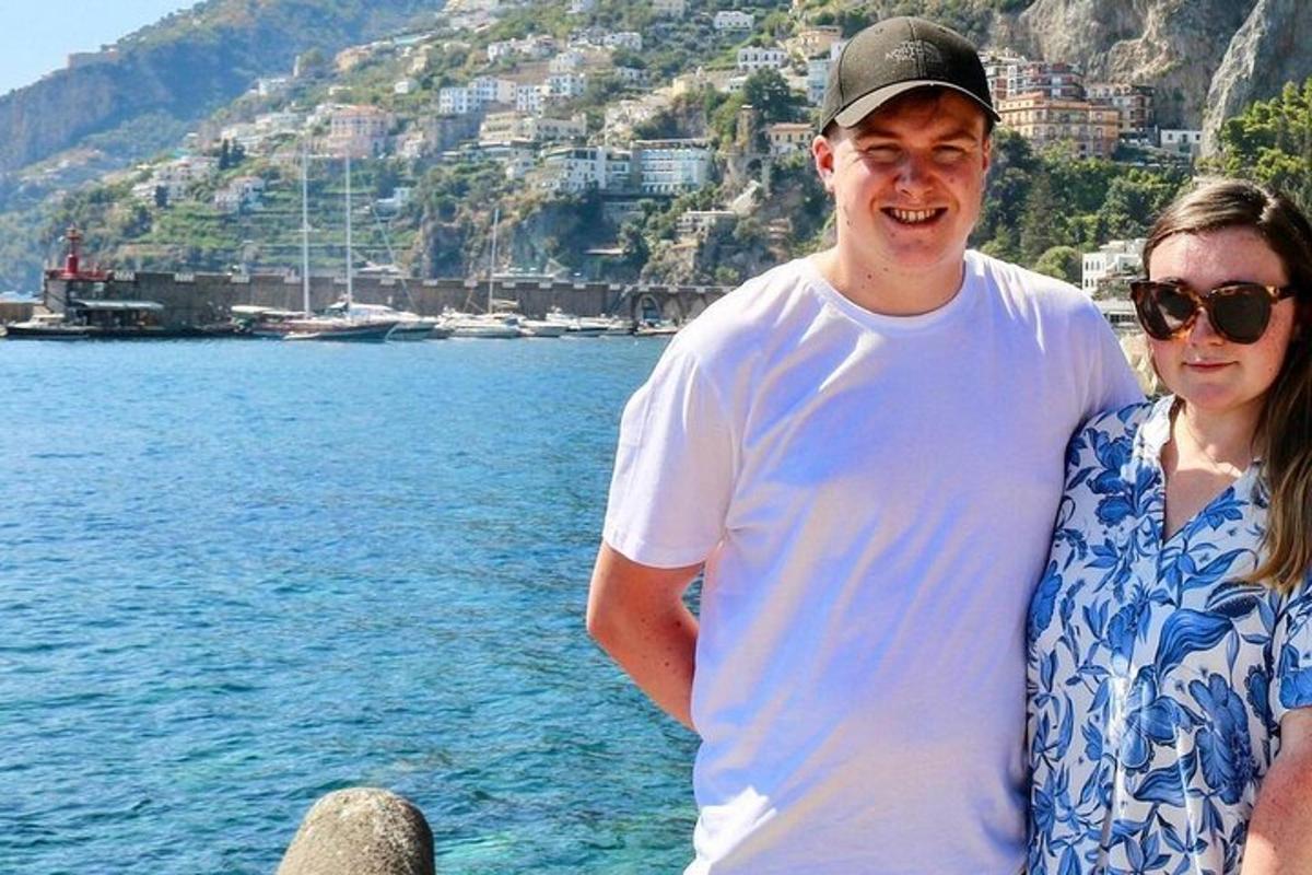 Un hombre y una mujer de pie junto al agua