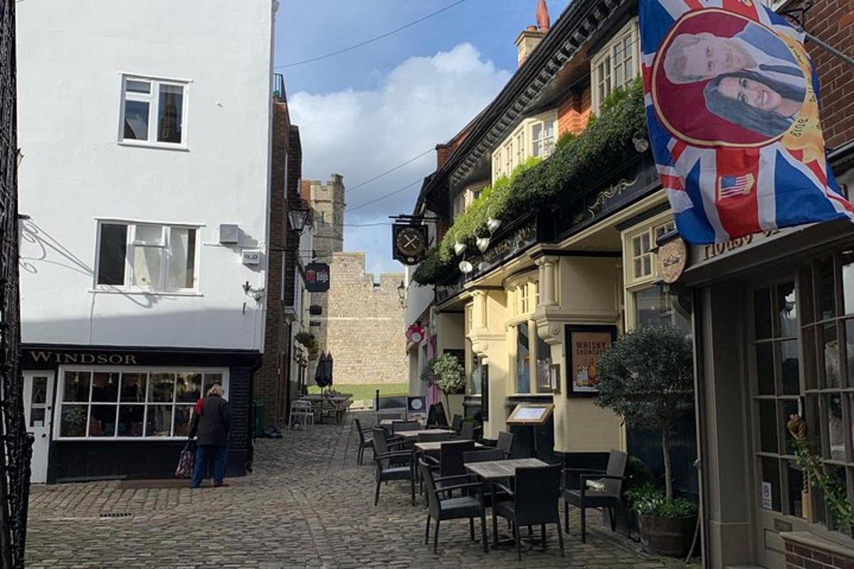a cobblestone street with tables and chairs in front of buildings