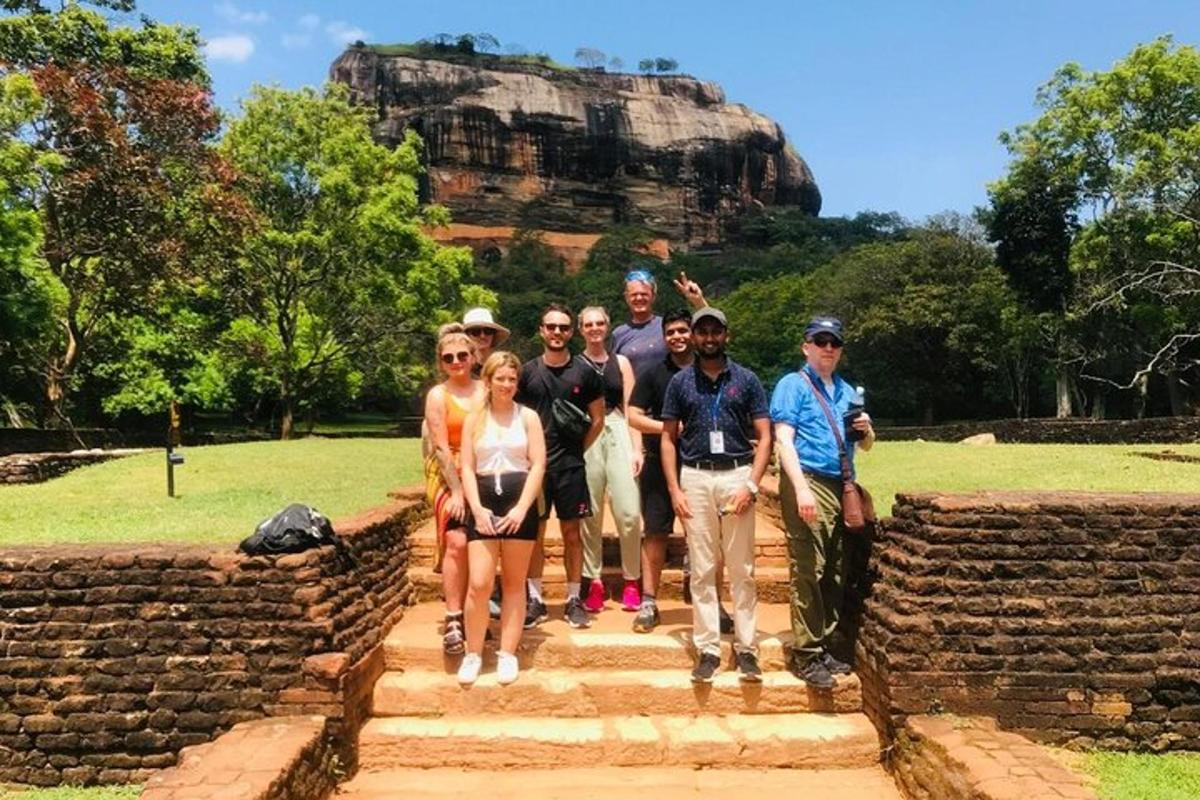 a group of people standing on steps at the lion rock