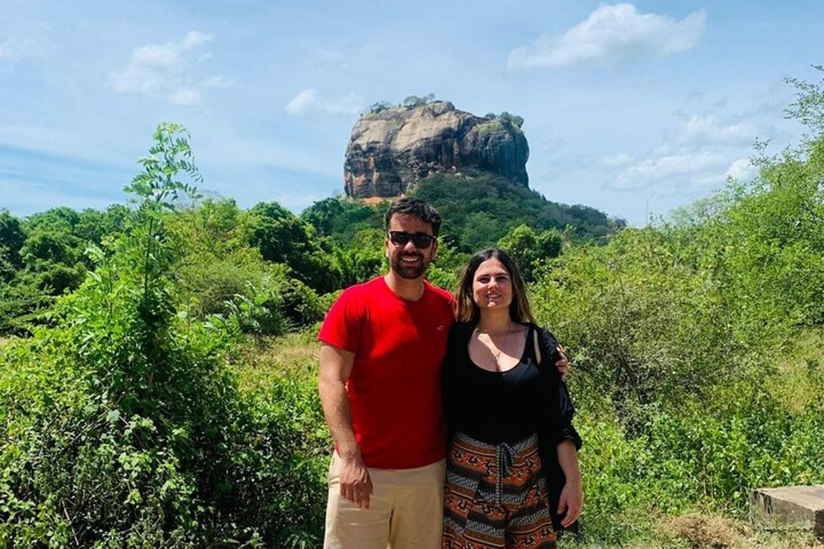 a man and a woman standing in front of a mountain