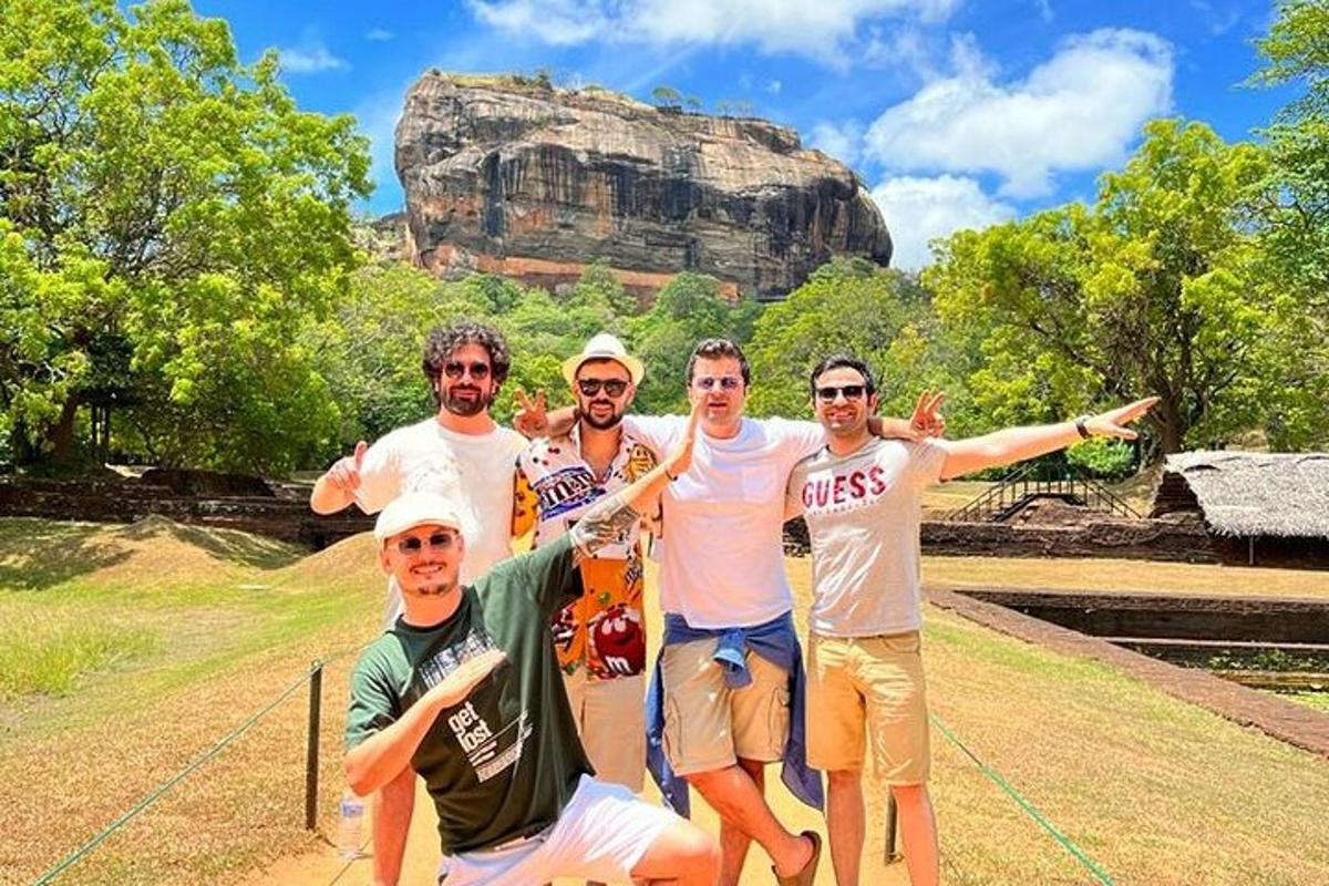 a group of men posing in front of a mountain