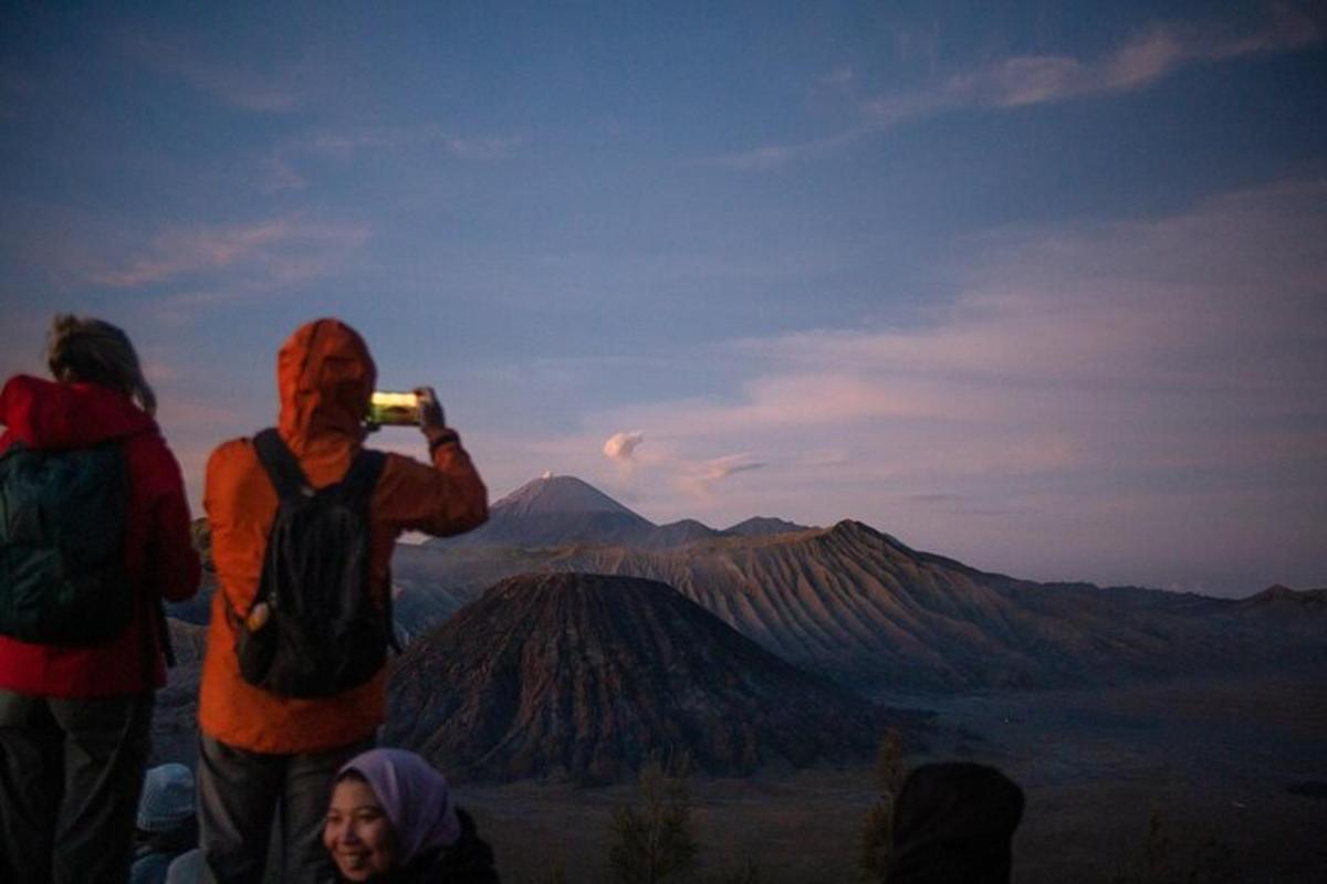 a man taking a picture of a mountain