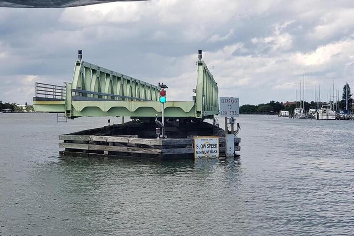 a green bridge on a dock in the water