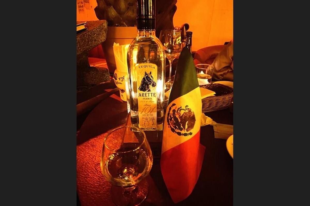 two bottles of wine and a glass on a table
