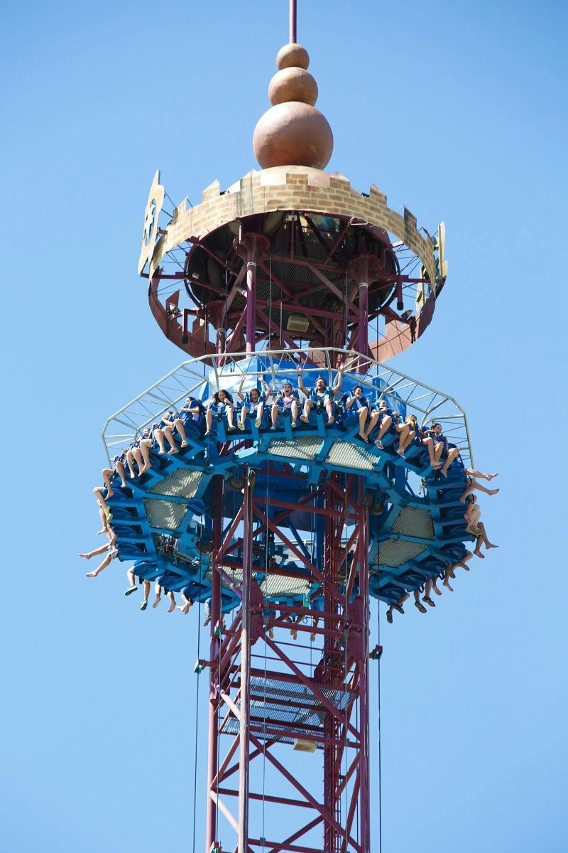 a group of people on the top of a roller coaster