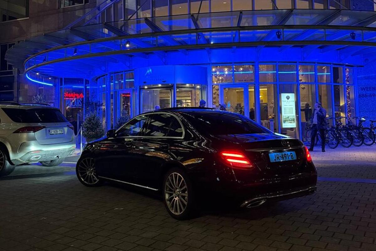 a black car parked in front of a building at night