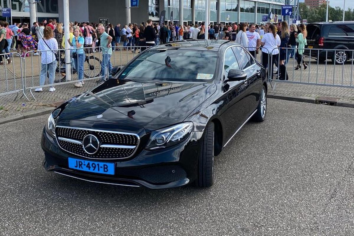 a car parked on a street with a crowd of people