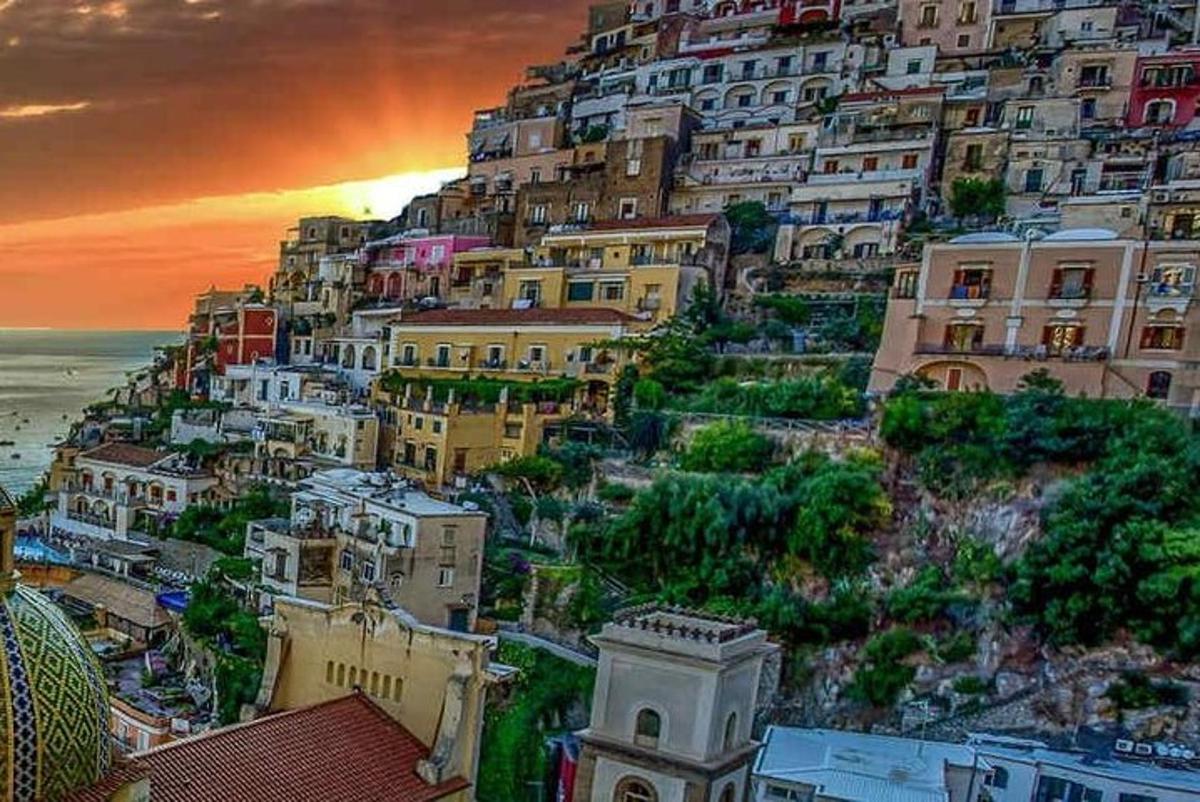 un gruppo di edifici su una collina con l'oceano