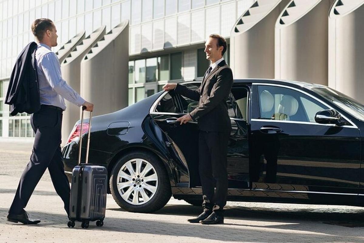 two men are getting out of a black car