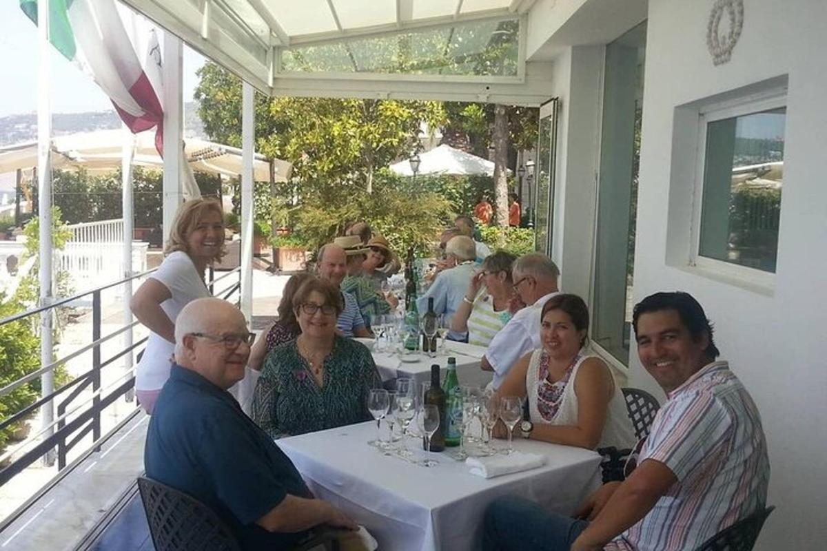 μια ομάδα ανθρώπων που κάθονται σε ένα τραπέζι σε ένα εστιατόριο