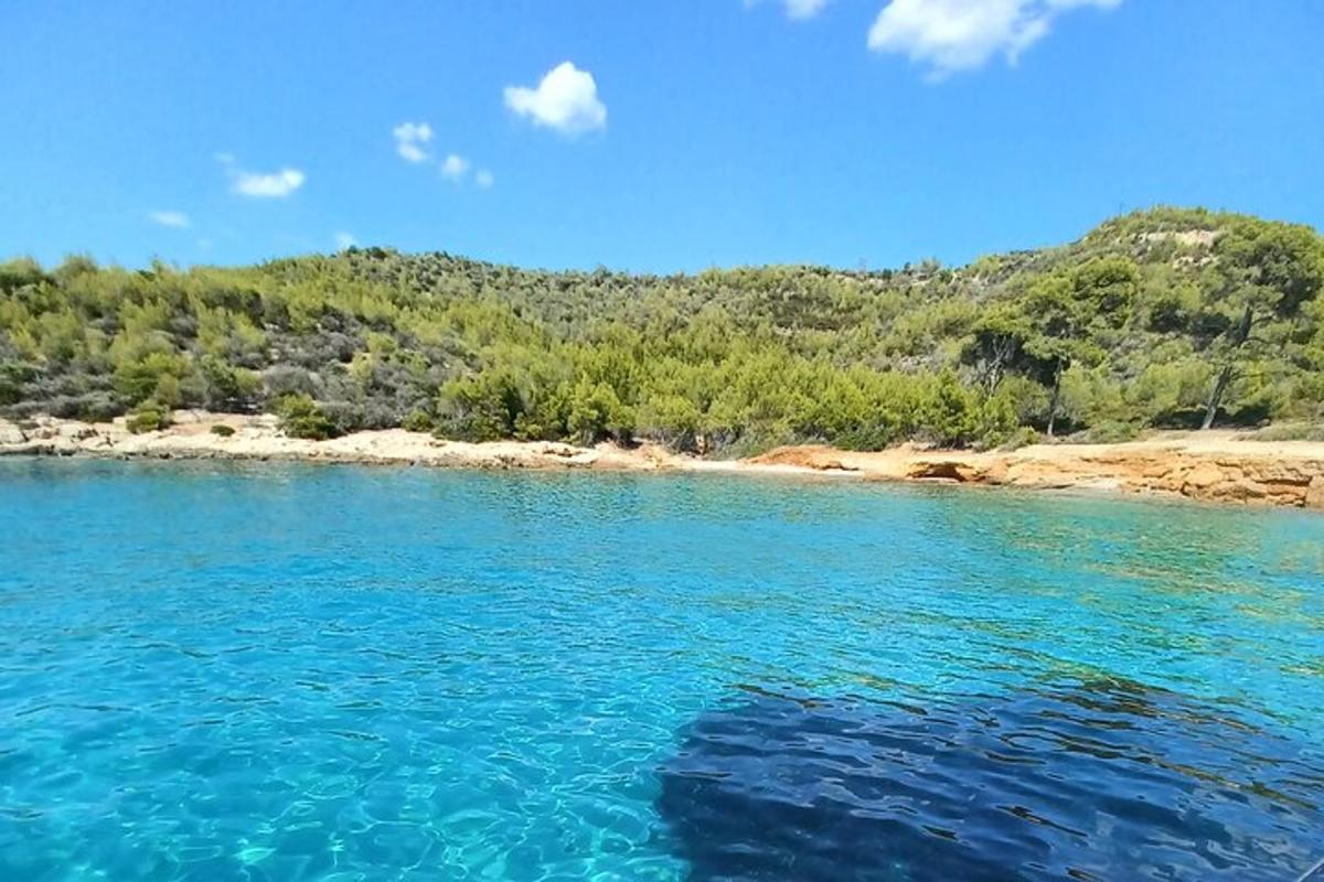 a large body of water with a beach in the background