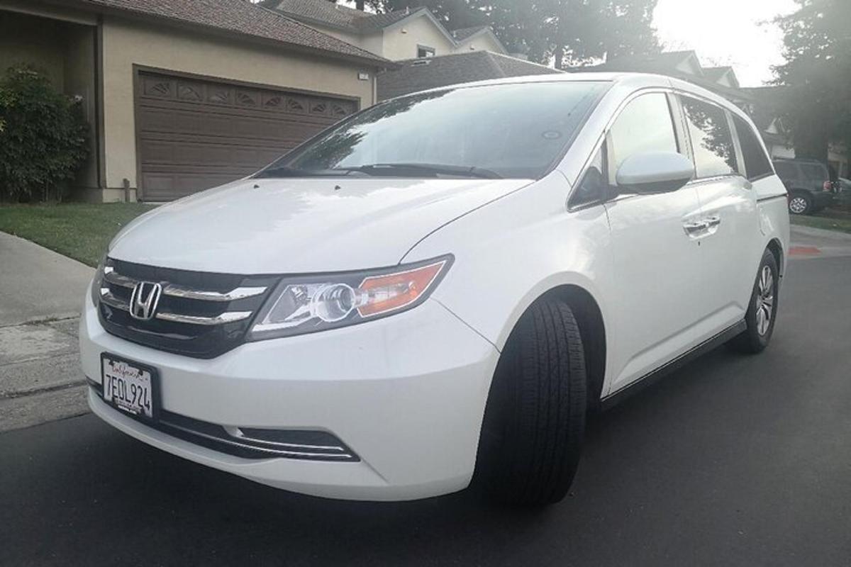 a white car is parked in a driveway