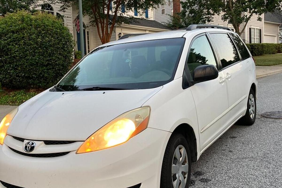 a white car parked on the side of a street