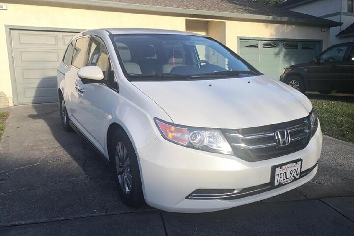 a white car parked in front of a house