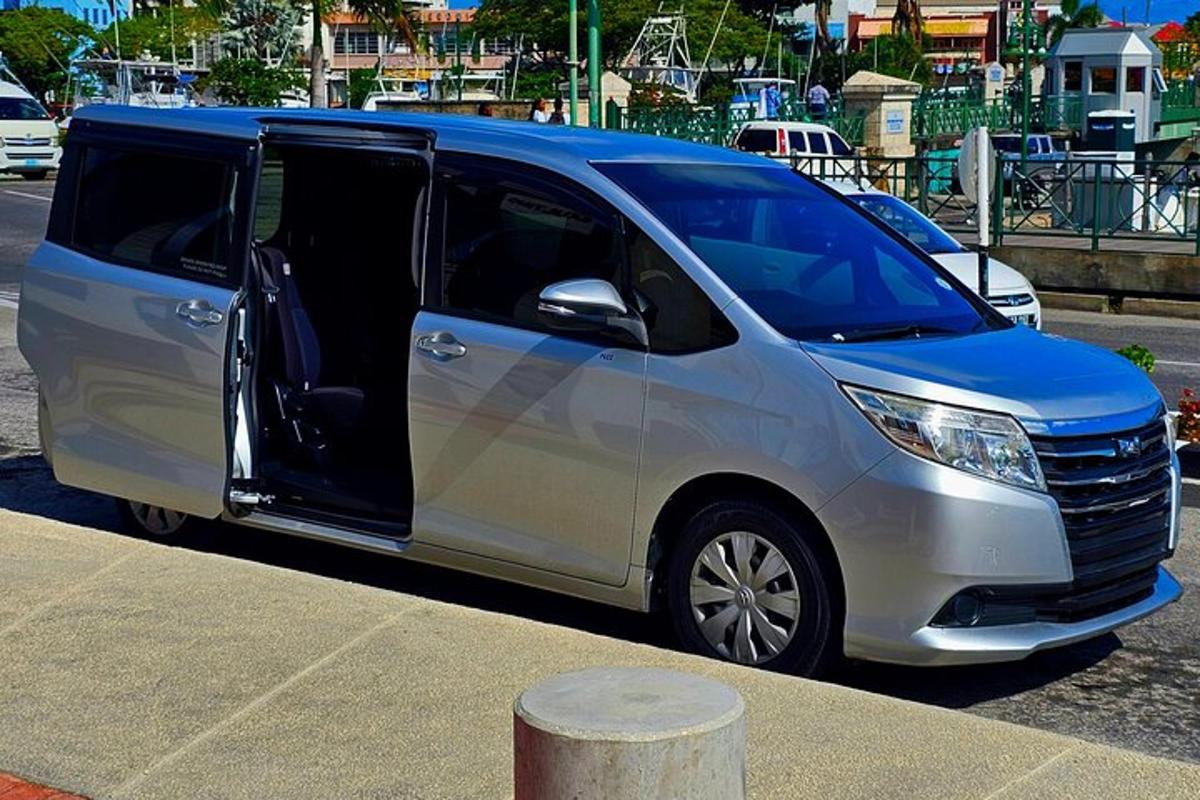 a silver van parked in a parking lot with its door open