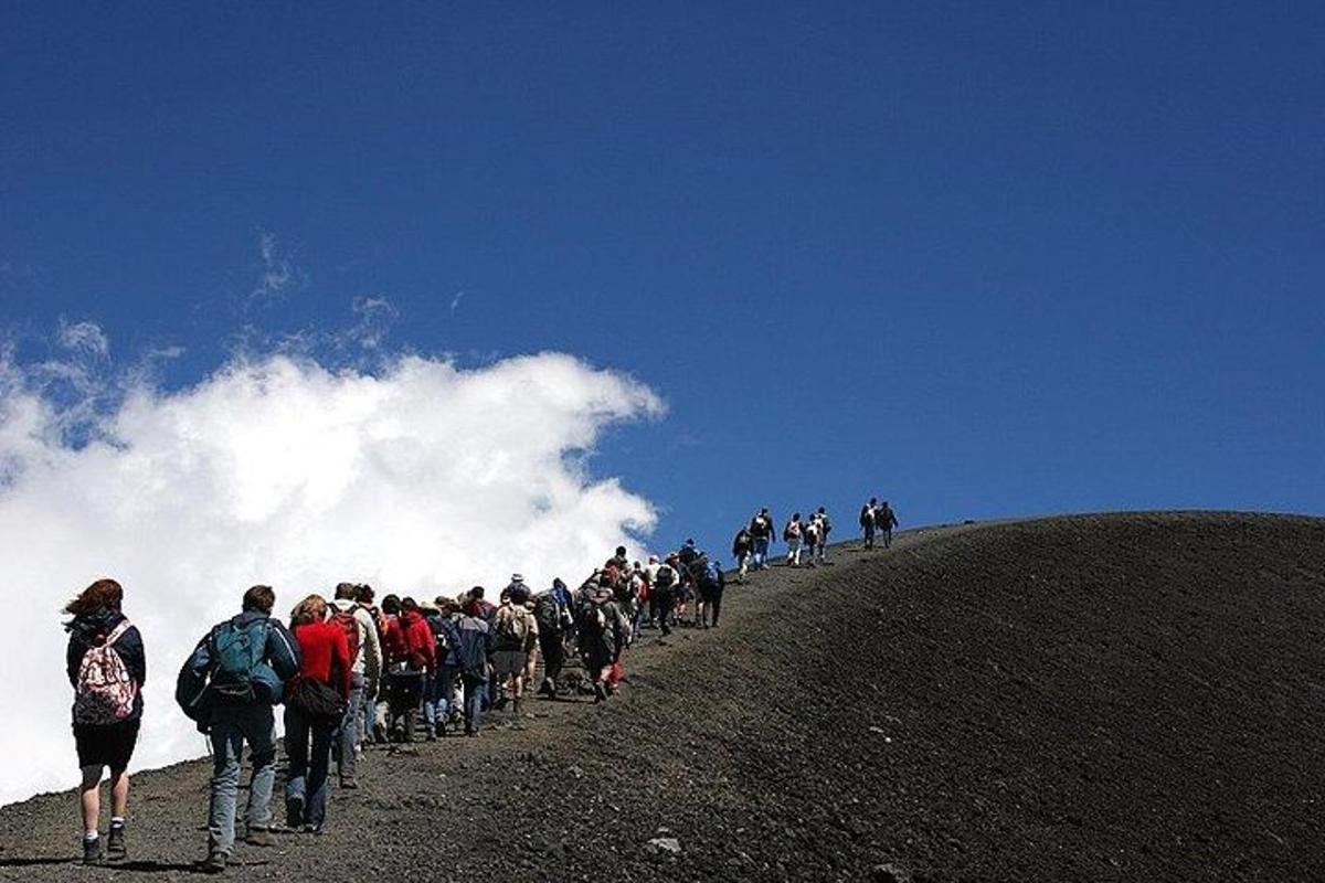 a group of people walking up a hill