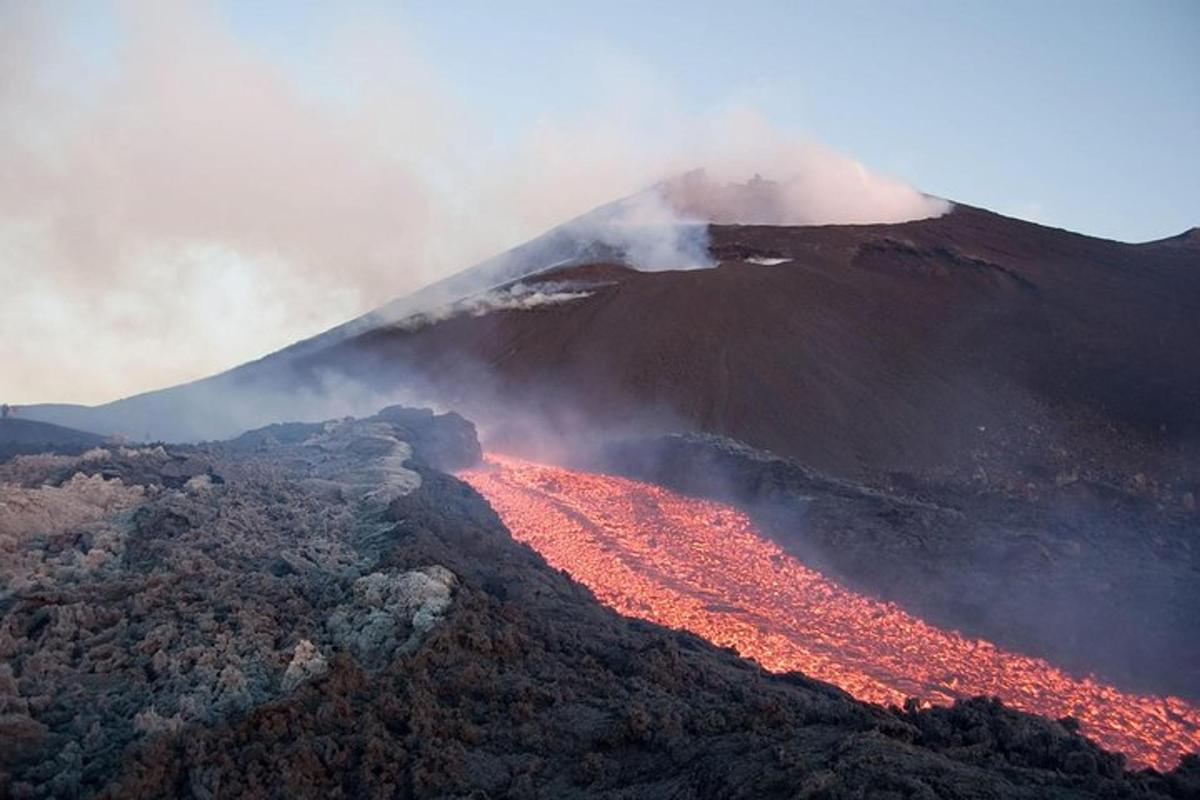 a volcano with red lava on top of a mountain