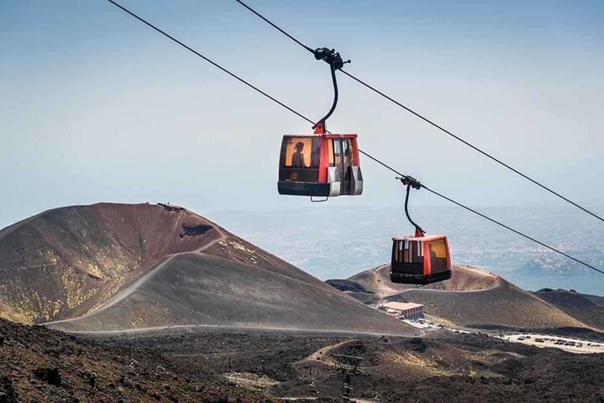two gondolas on a ski lift over a mountain