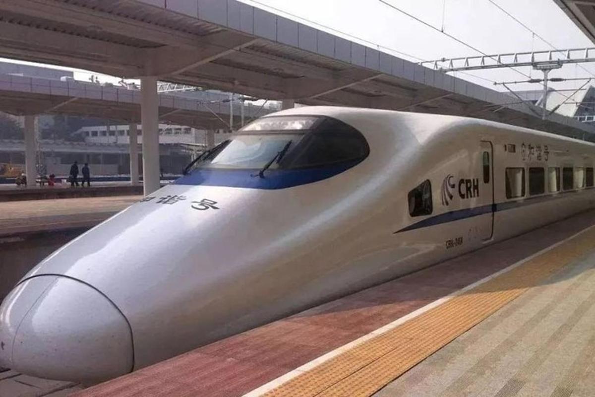 a white train is parked at a train station