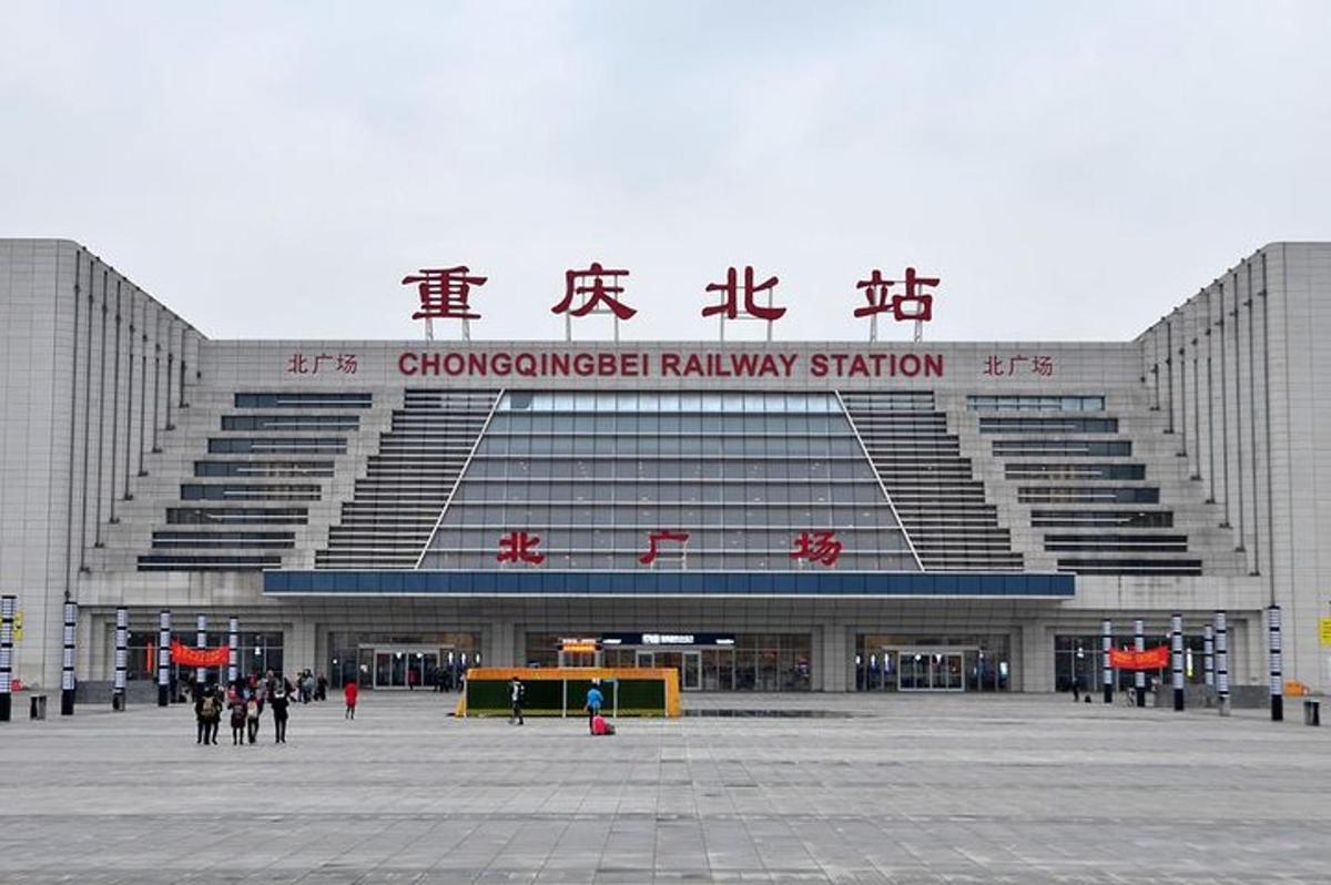 a large stadium with people walking in front of it