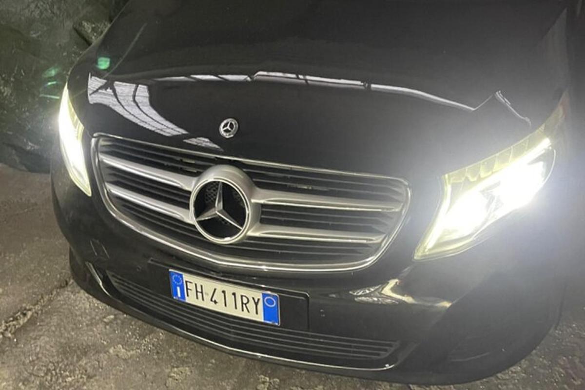a black car is parked on the street