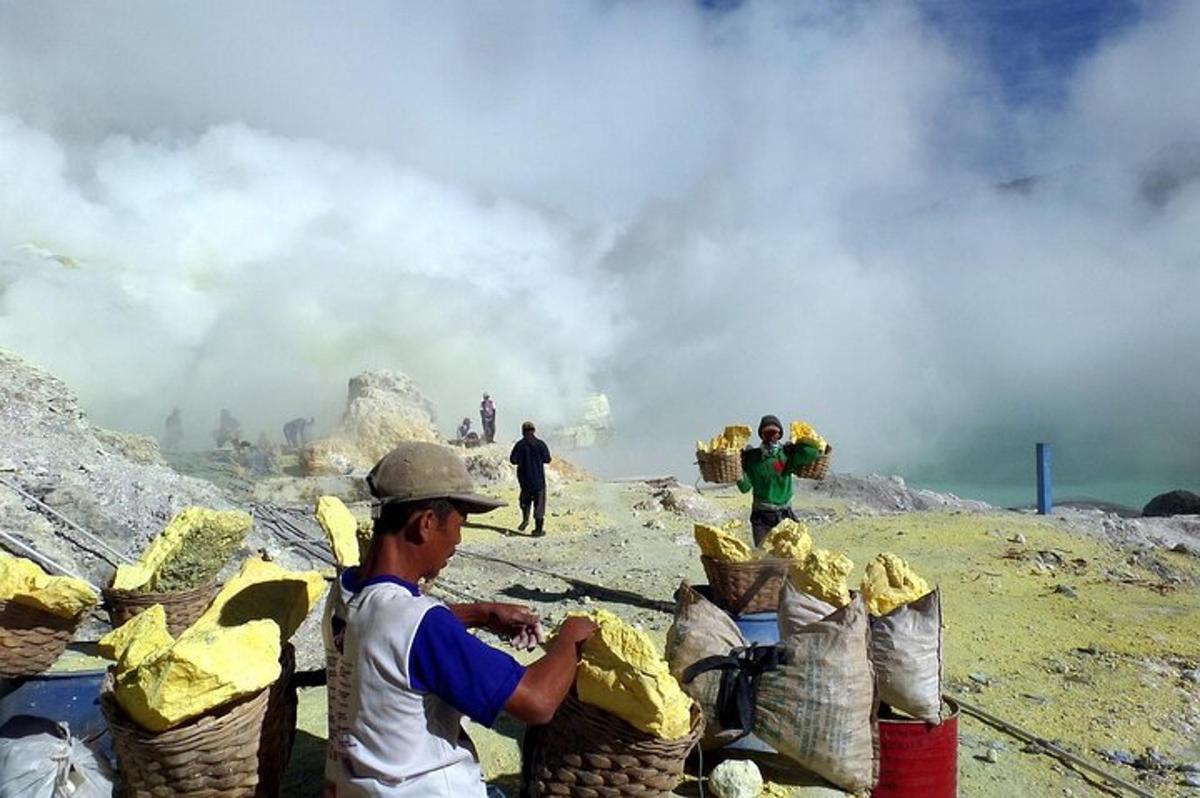a man standing in front of a pile of baskets