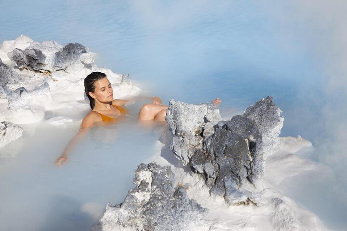a woman laying in a bath tub in the water
