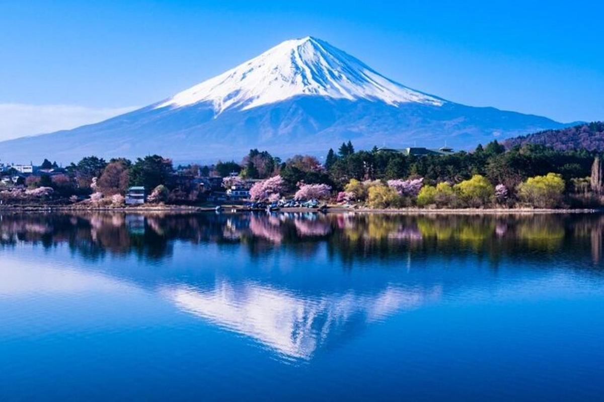 a mountain with a reflection in the water with trees