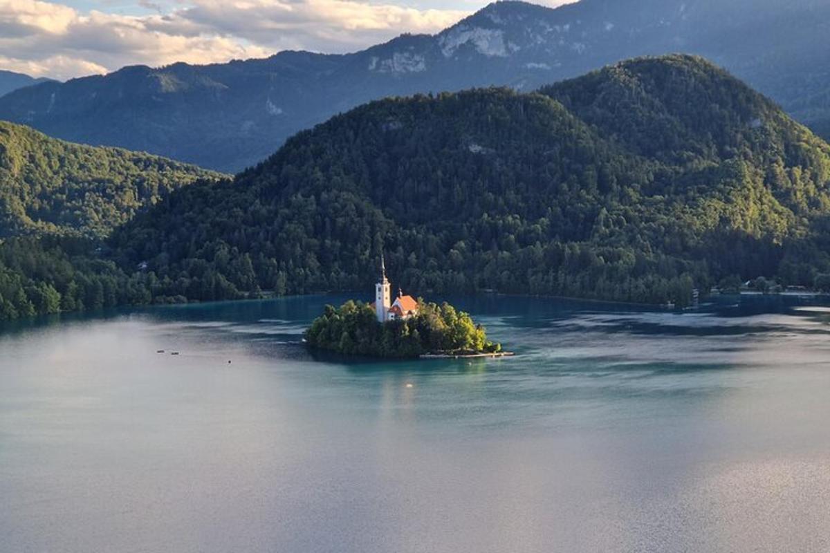 an island with a church in the middle of a lake