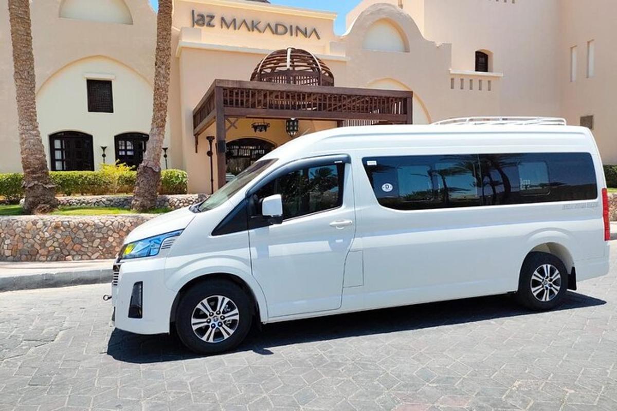 sebuah mobil van putih diparkir di depan sebuah gedung